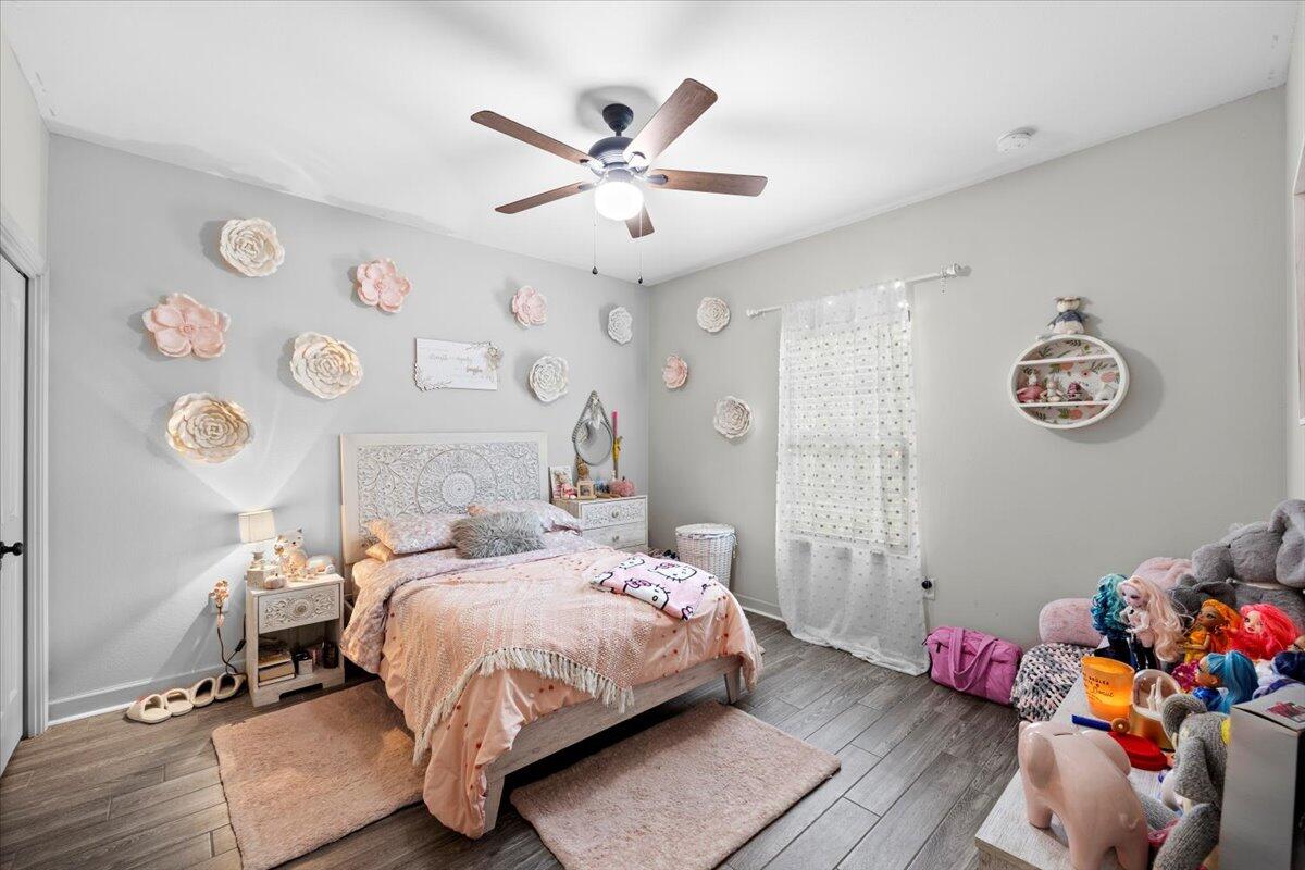 6057 Diamante Drive Crestview, FL 32539 - Photo 23 of 33 a bedroom with a bed and wooden floor