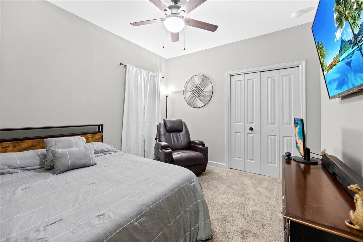 6057 Diamante Drive Crestview, FL 32539 - Photo 24 of 33 a bedroom with a bed and a chandelier