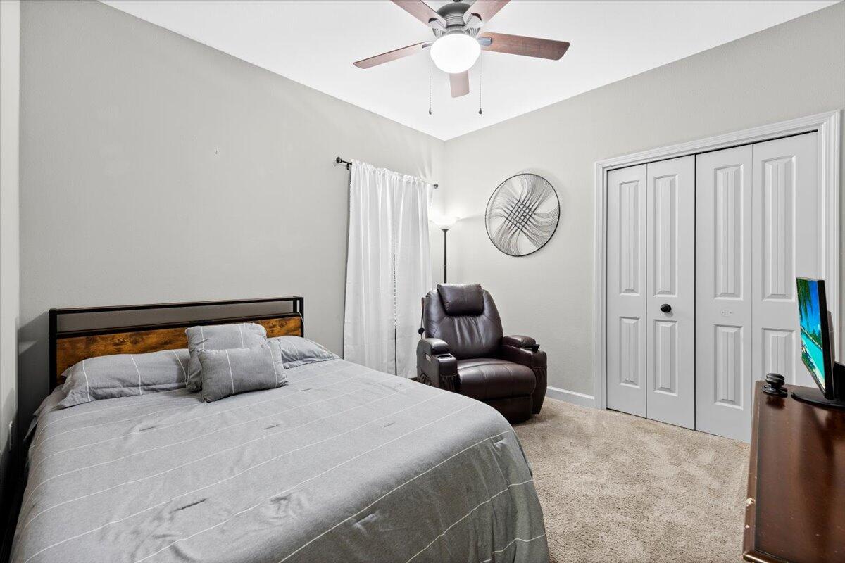 6057 Diamante Drive Crestview, FL 32539 - Photo 25 of 33 a bedroom with a bed and a chandelier