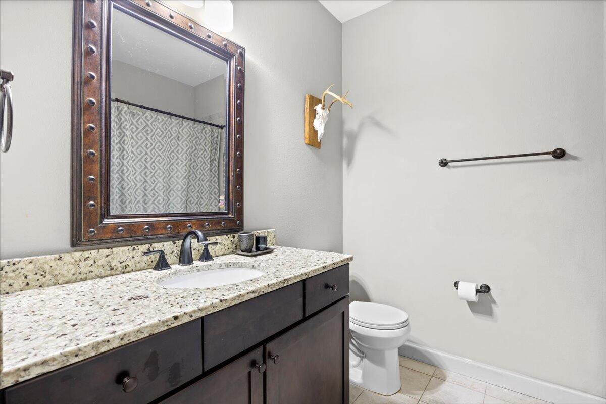 6057 Diamante Drive Crestview, FL 32539 - Photo 26 of 33 a bathroom with a granite countertop sink toilet and mirror