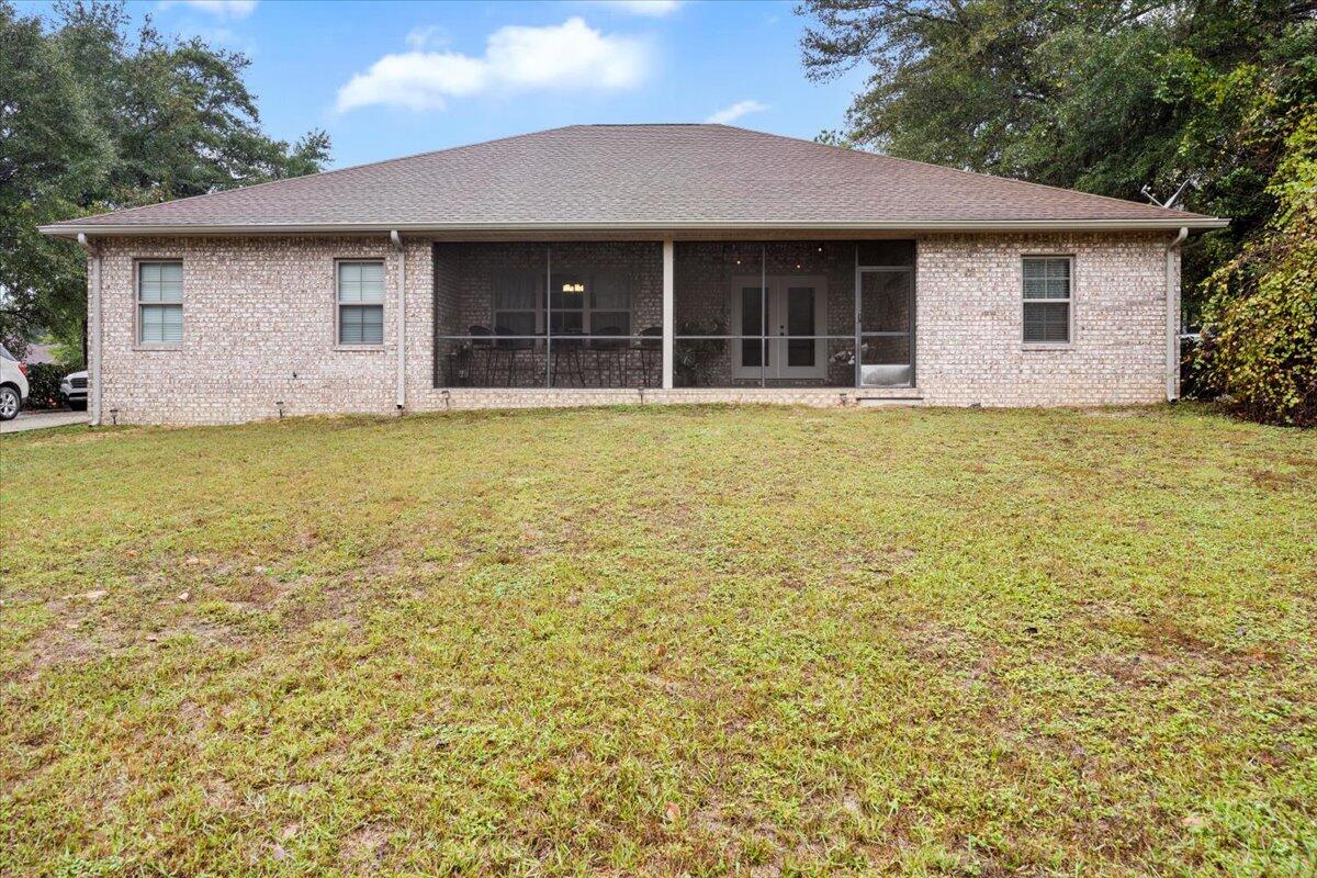6057 Diamante Drive Crestview, FL 32539 - Photo 32 of 33 a house with a yard