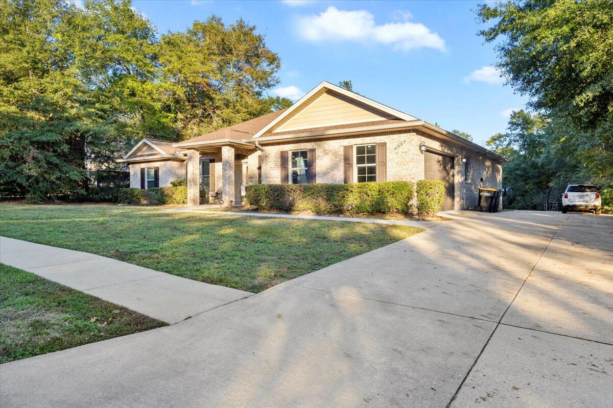 6057 Diamante Drive Crestview, FL 32539 - Photo 4 of 33 a front view of a house with a yard