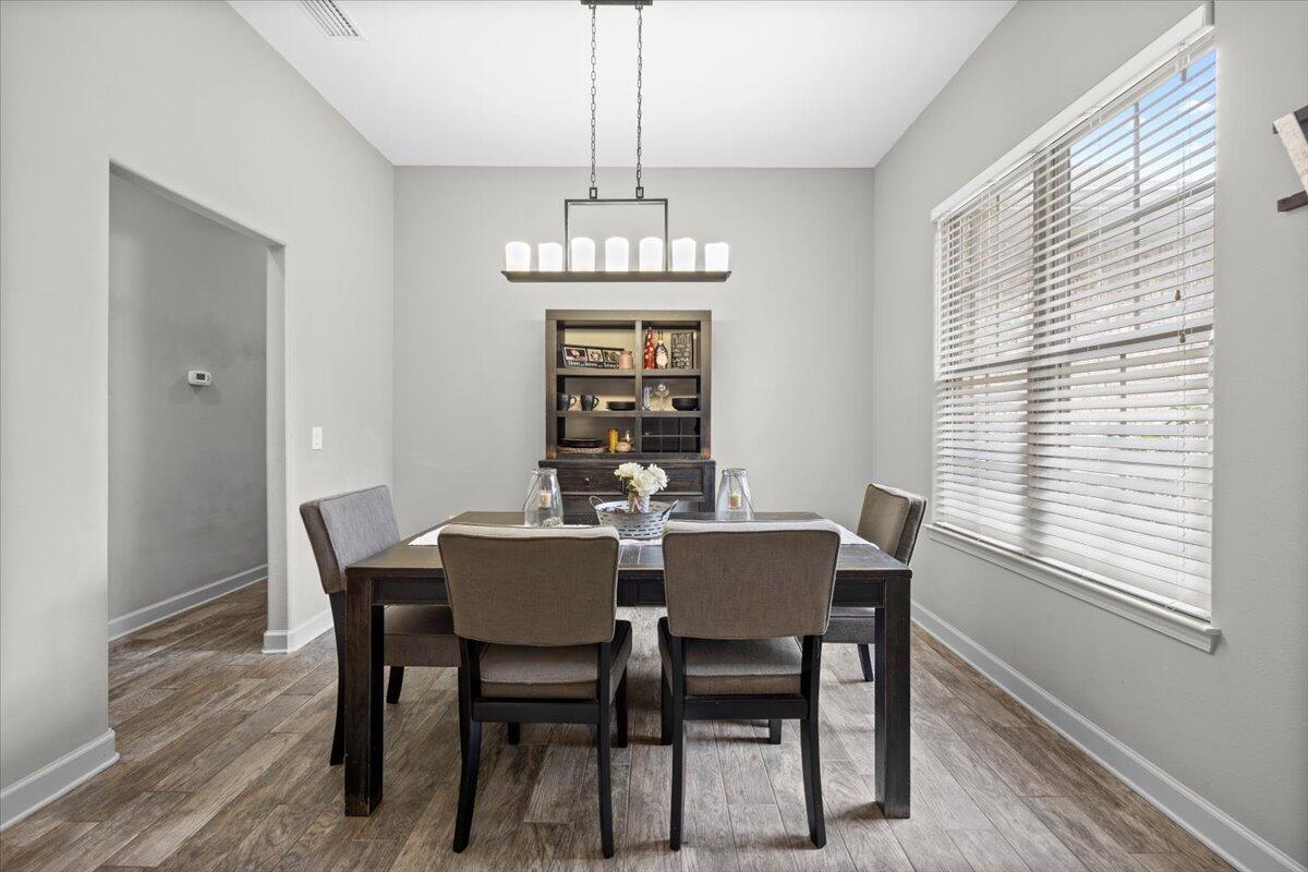 6057 Diamante Drive Crestview, FL 32539 - Photo 6 of 33 a view of a dining room with furniture window and wooden floor