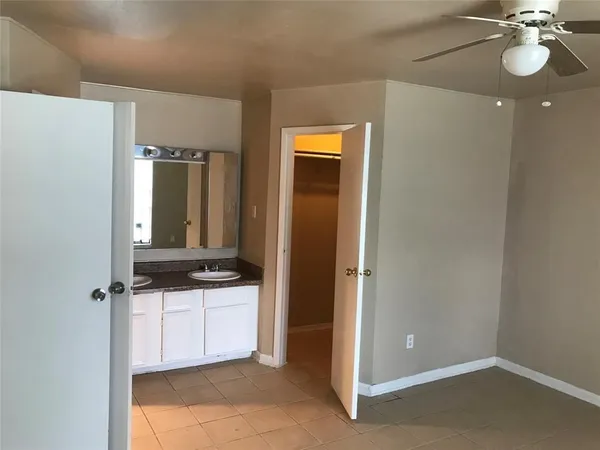 a bathroom with a sink a light fixture and a mirror