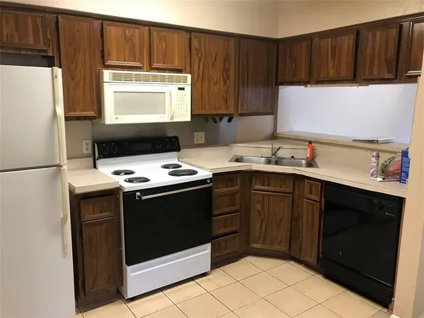 a kitchen with stainless steel appliances a stove a microwave and a refrigerator