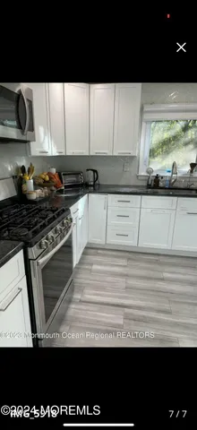 a living room with lots of counter space and a window