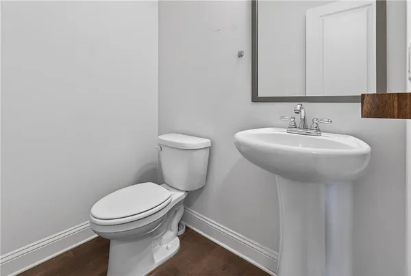 a white toilet sitting next to a bathroom sink