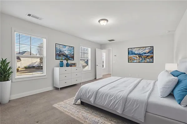 a bedroom with a bed and a potted plant