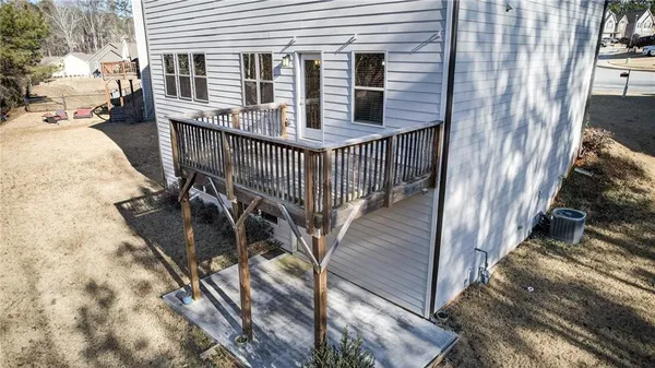 an aerial view of a house with a yard and tree s