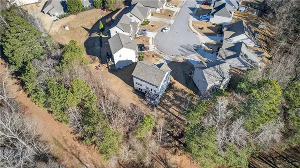 an aerial view of a house with a big yard
