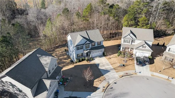 an aerial view of a house with a yard