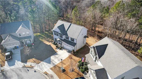 an aerial view of a house with a swimming pool and outdoor seating