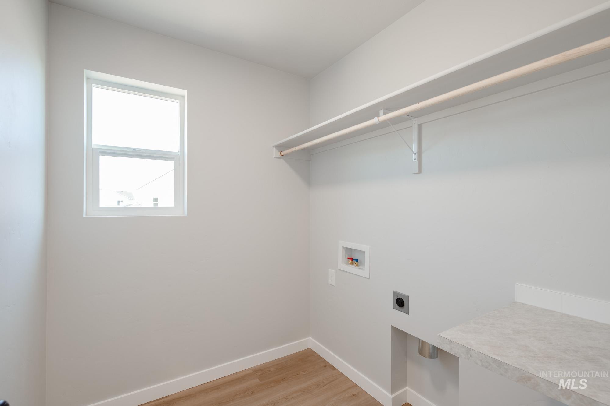 13727 Judson Street Caldwell, ID 83607 - Photo 17 of 26 Laundry area featuring light wood-style flooring, hookup for a washing machine, and electric dryer hookup