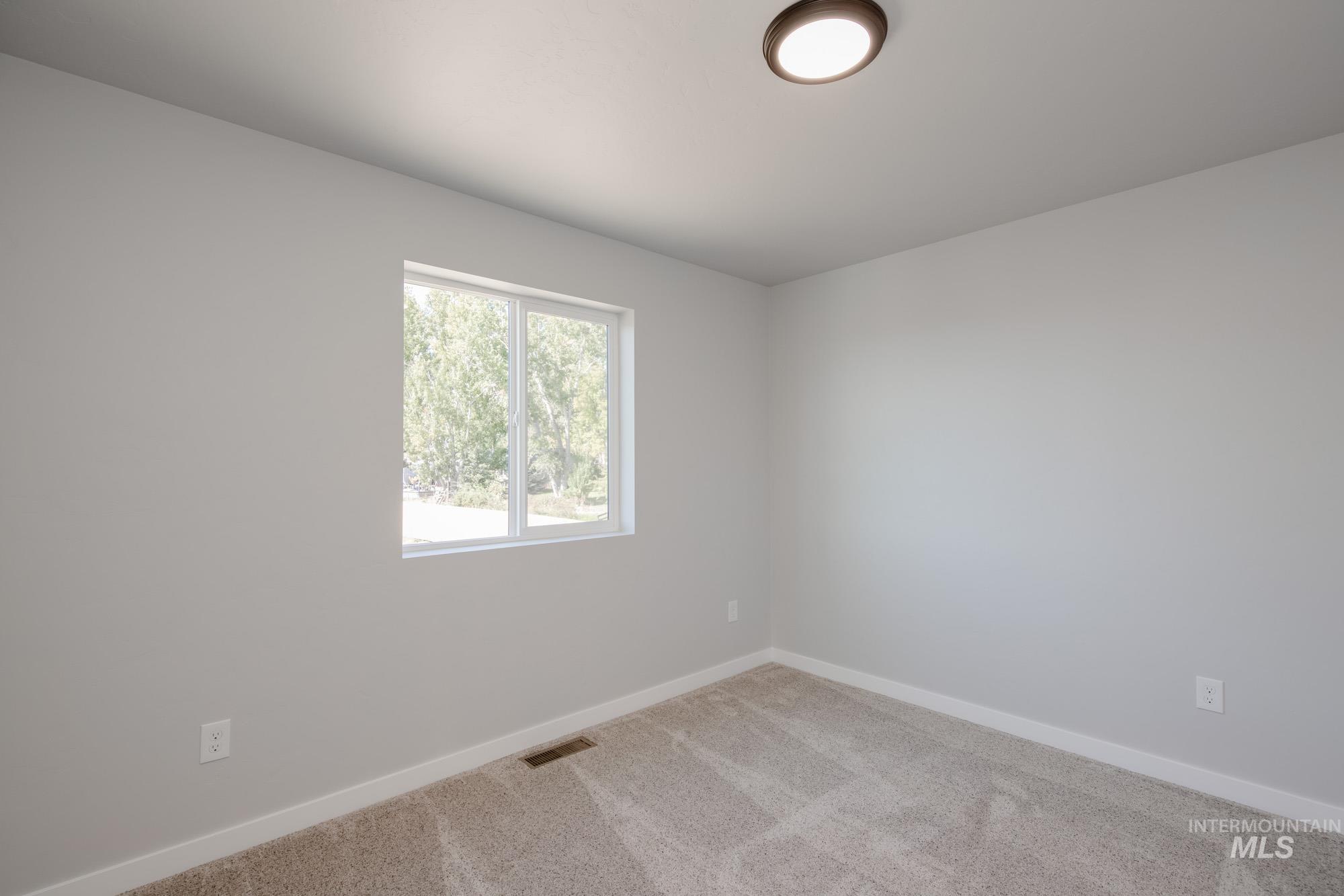 13727 Judson Street Caldwell, ID 83607 - Photo 22 of 26 Carpeted empty room featuring baseboards