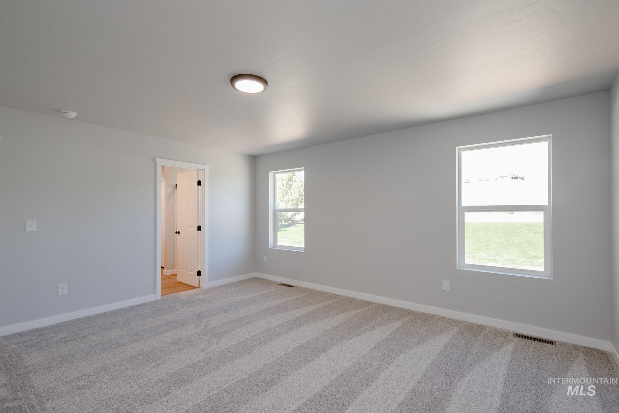 13727 Judson Street Caldwell, ID 83607 - Photo 24 of 26 Spare room with light carpet and baseboards