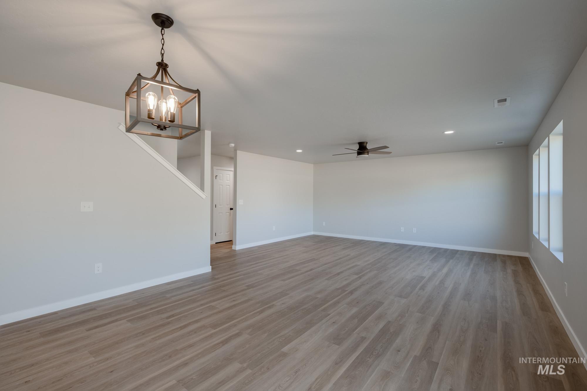 13727 Judson Street Caldwell, ID 83607 - Photo 9 of 26 Unfurnished living room featuring light wood-style floors, recessed lighting, ceiling fan, and a chandelier