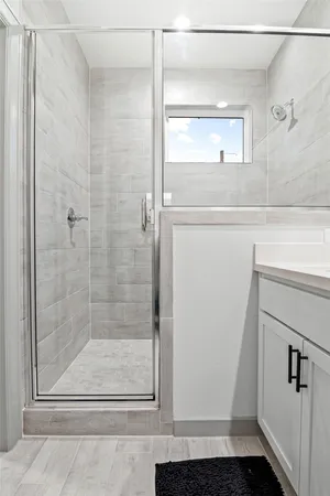 a bathroom with a glass shower door