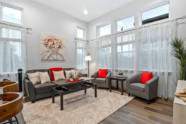 a living room with furniture and a large window