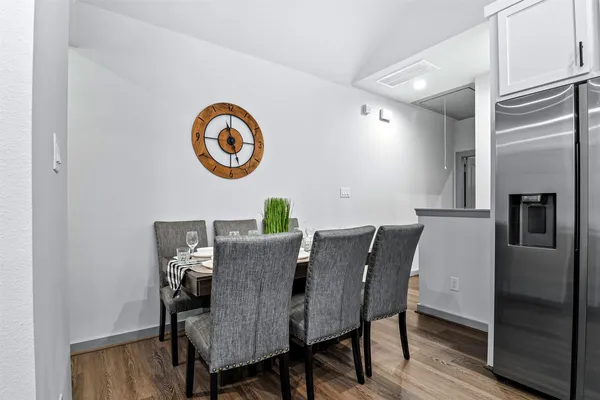 a view of a dining room with furniture and wooden floor