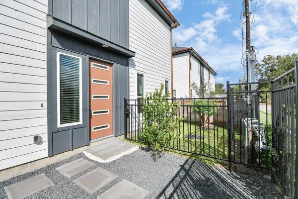a view of a house with a wooden fence