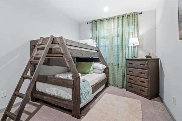 a bedroom with a bunk bed and a dresser