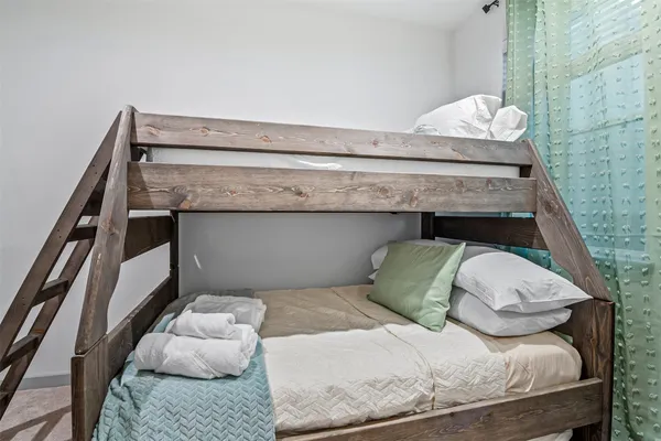 a bedroom with a bed and a mirror