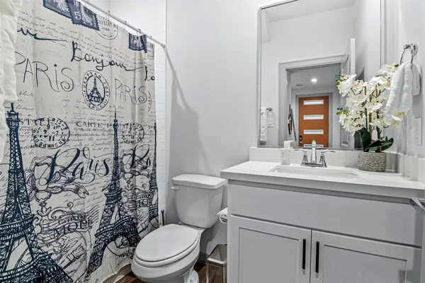 a bathroom with a toilet sink and mirror