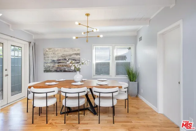 a dining room with furniture a rug and a chandelier