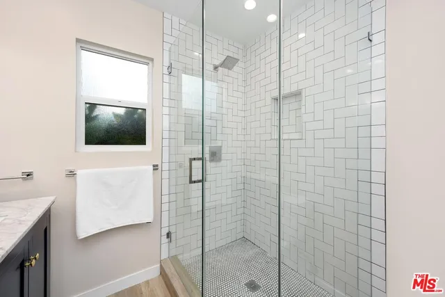 a bathroom with a shower and a sink