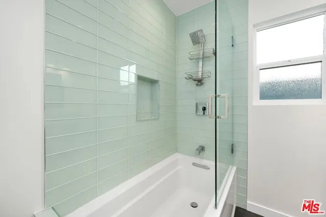 a bathroom with a bathtub and a shower