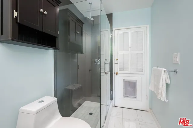 a bathroom with a toilet and a shower