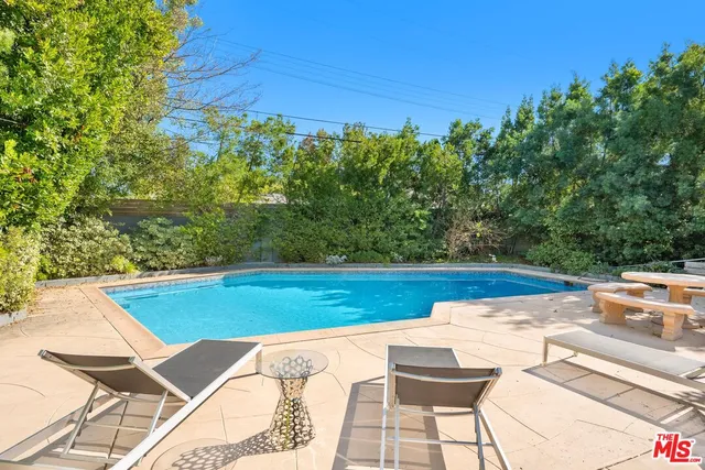 a view of a swimming pool with a patio