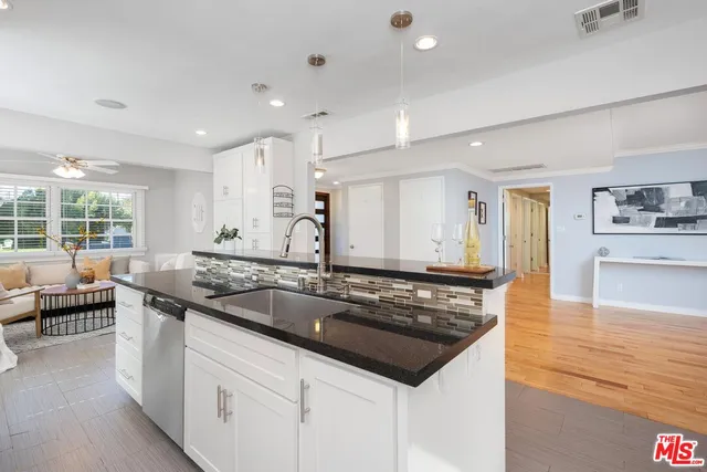 a kitchen that has a sink and a stove in it