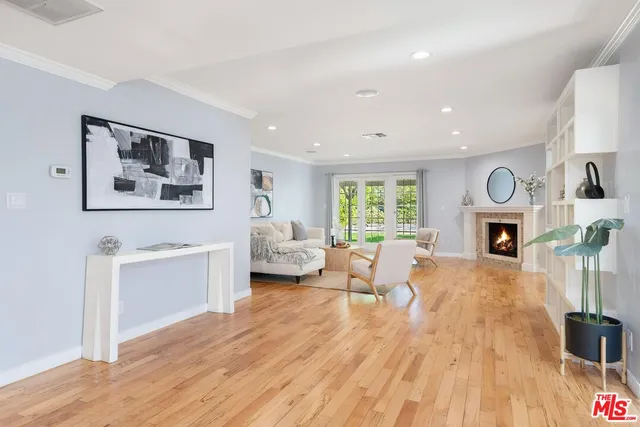 a living room with furniture a fireplace and a wooden floor