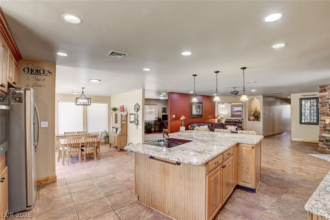 1950 Bowman Road Logandale, NV 89021 - Photo 15 of 81 A sprawling open-concept design unites the kitchen, dining area, and living space for effortless entertaining.