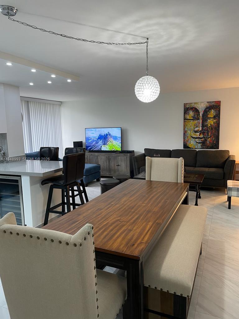 16919 North Bay Road, Unit 104 Sunny Isles Beach, FL 33160 - Photo 17 of 32 a view of a dining room with furniture