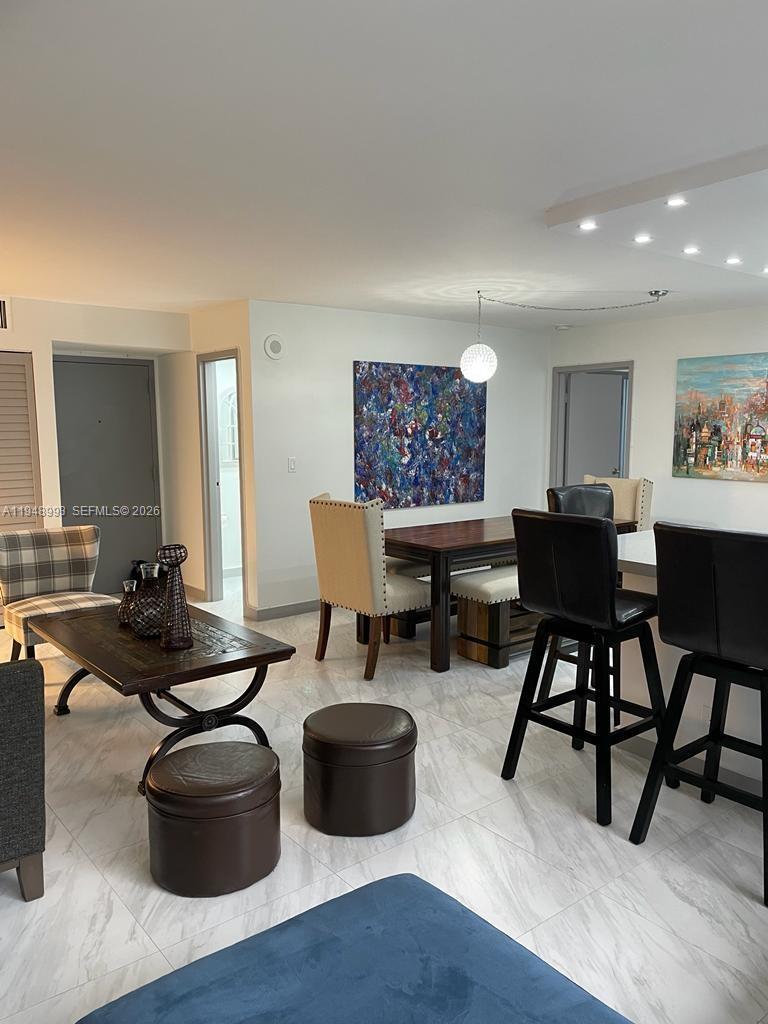 16919 North Bay Road, Unit 104 Sunny Isles Beach, FL 33160 - Photo 18 of 32 a living room with furniture rug and wooden floor