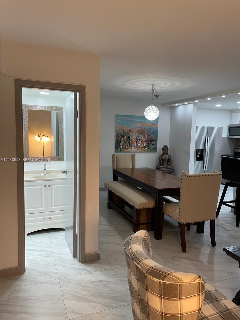 16919 North Bay Road, Unit 104 Sunny Isles Beach, FL 33160 - Photo 20 of 32 a living room with furniture and a table