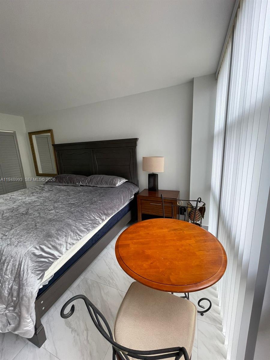 16919 North Bay Road, Unit 104 Sunny Isles Beach, FL 33160 - Photo 24 of 32 a view of a swimming pool with a chair and a window