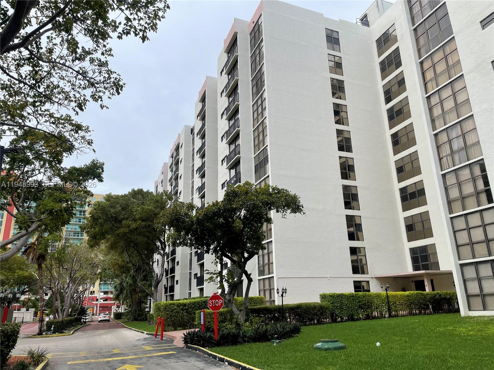 16919 North Bay Road, Unit 104 Sunny Isles Beach, FL 33160 - Photo 30 of 32 front view of a building with a street
