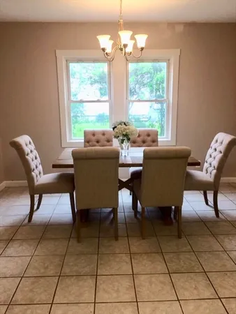 a dining room with furniture and window
