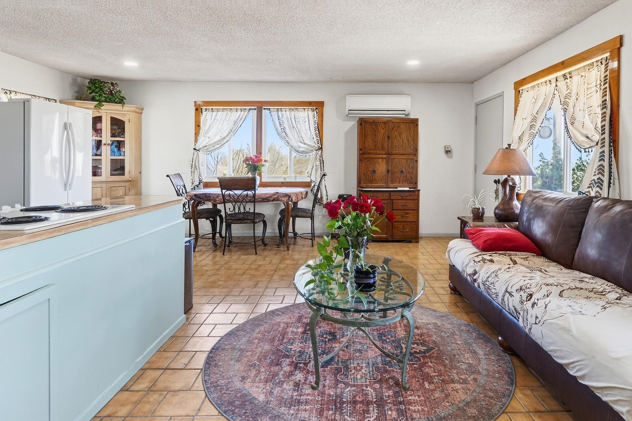 1588 Old Woman Springs Road Yucca Valley, CA 92284 - Photo 13 of 37 a living room with furniture potted plant and a large window