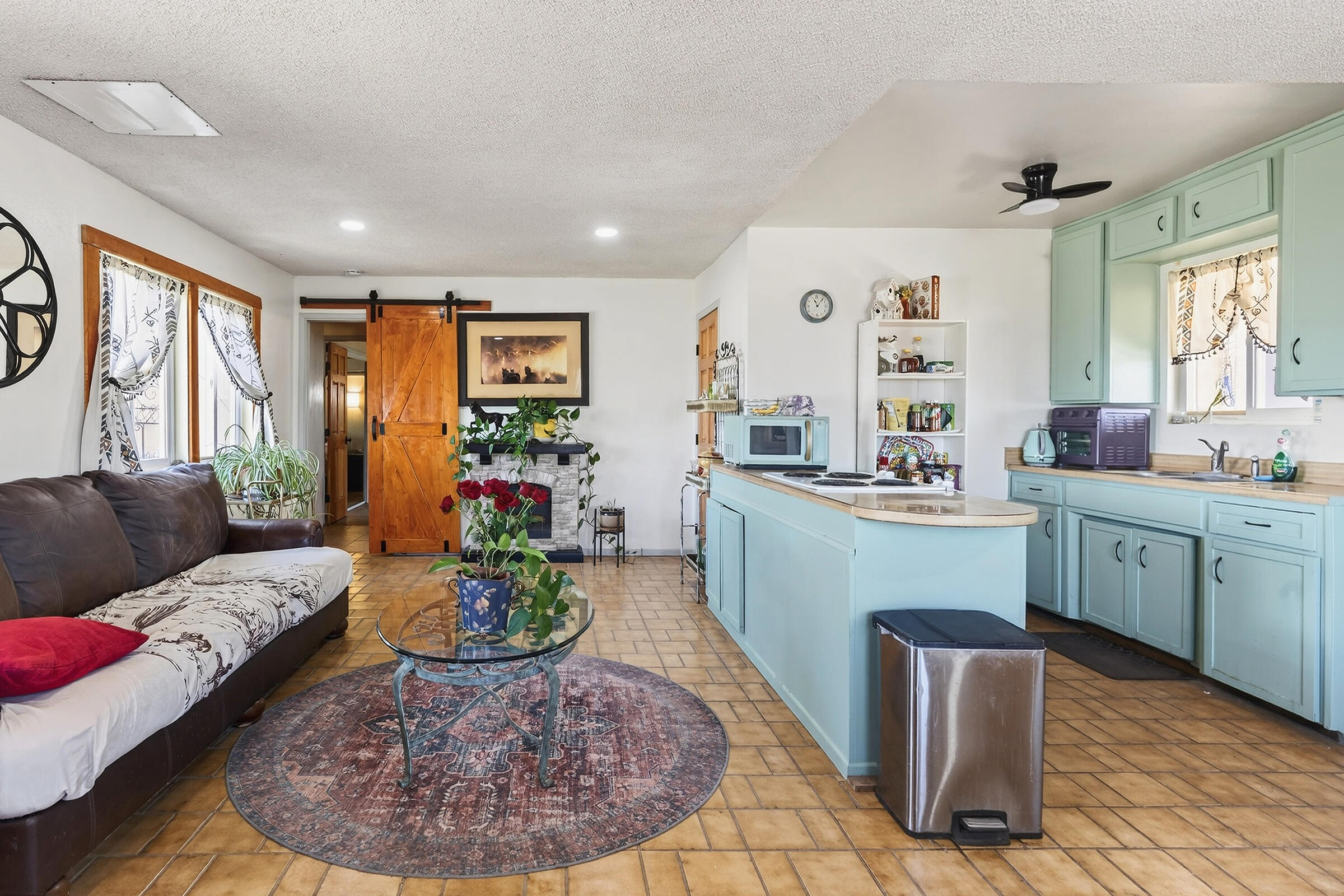 1588 Old Woman Springs Road Yucca Valley, CA 92284 - Photo 14 of 37 a living room with furniture and a large window