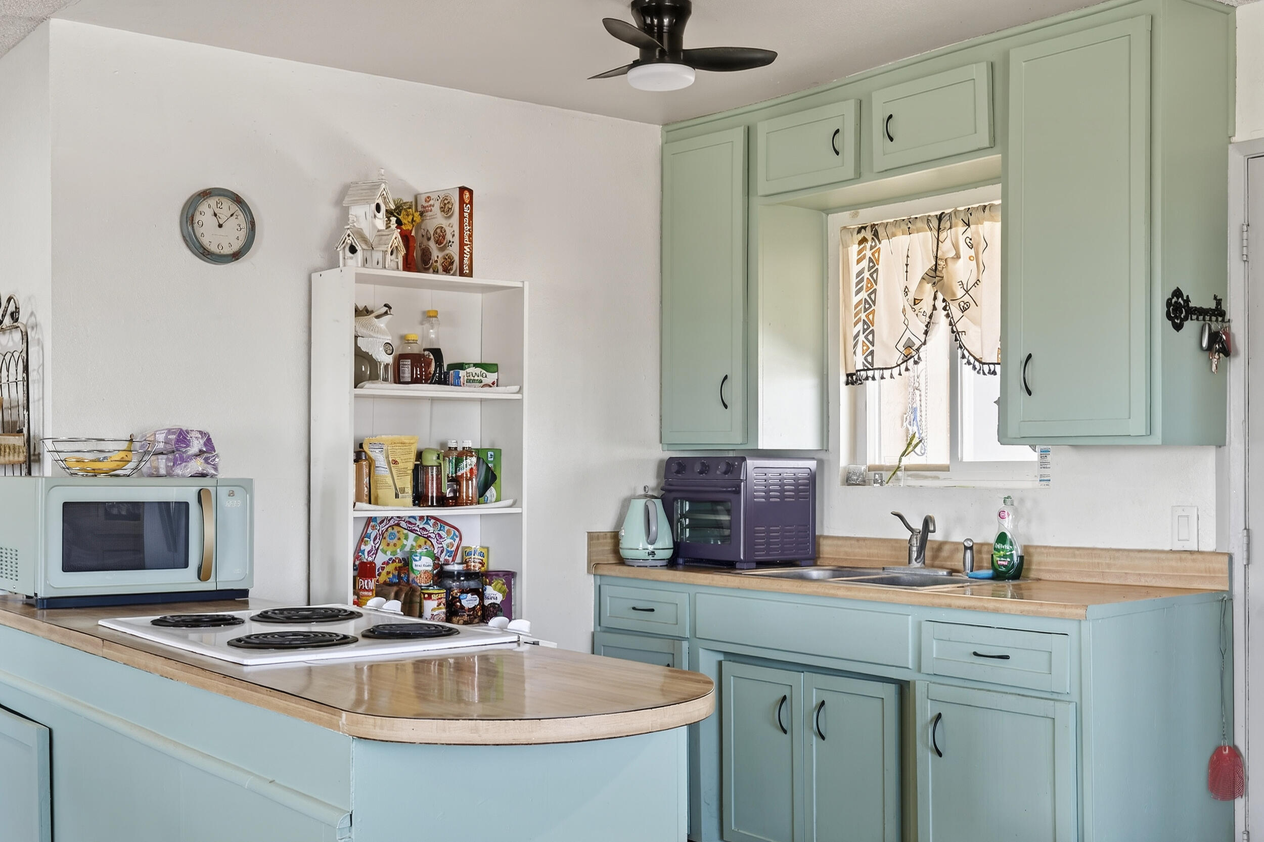 1588 Old Woman Springs Road Yucca Valley, CA 92284 - Photo 15 of 37 a kitchen with cabinets a window and appliances