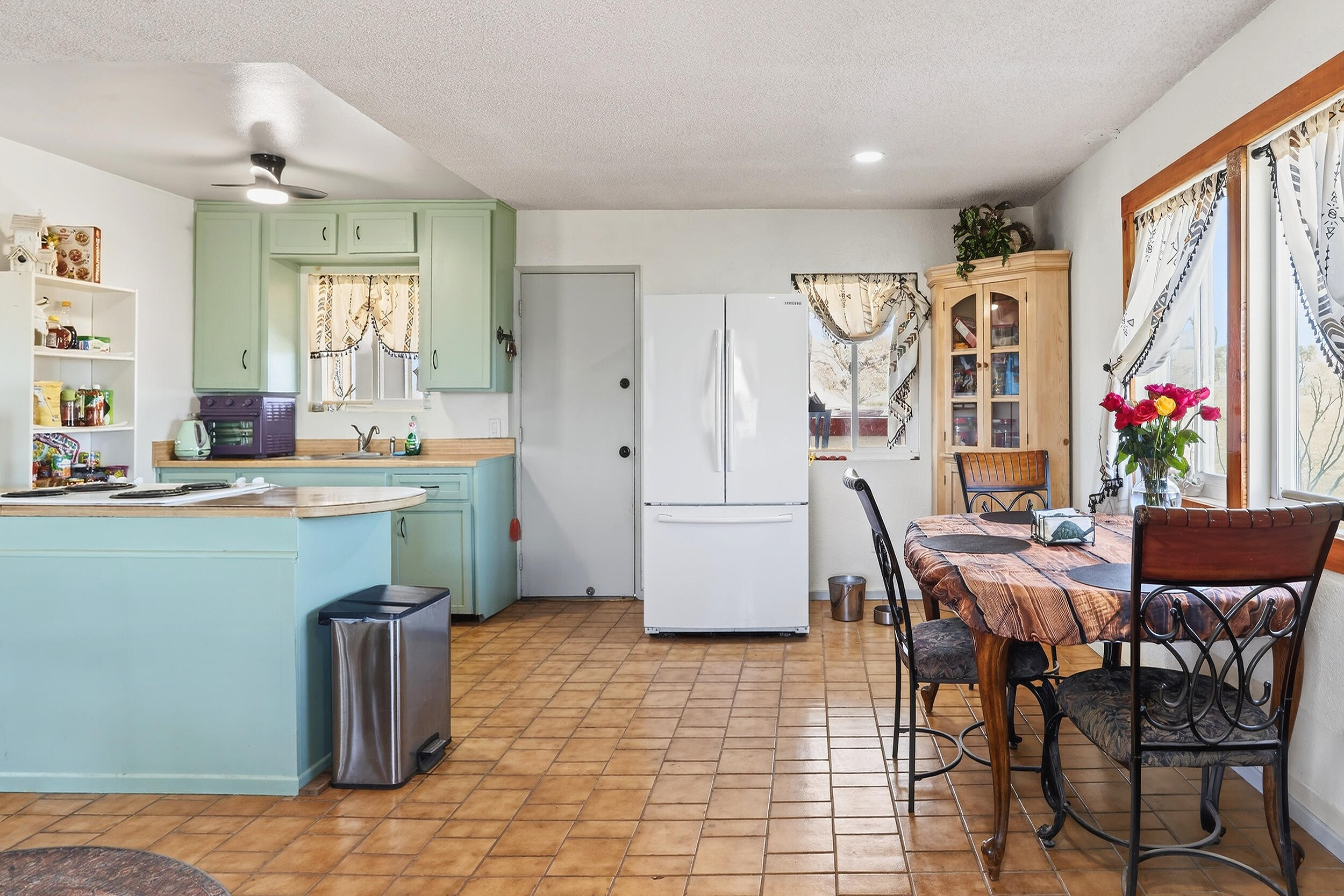 1588 Old Woman Springs Road Yucca Valley, CA 92284 - Photo 16 of 37 a room with granite countertop lots of wooden furniture and windows