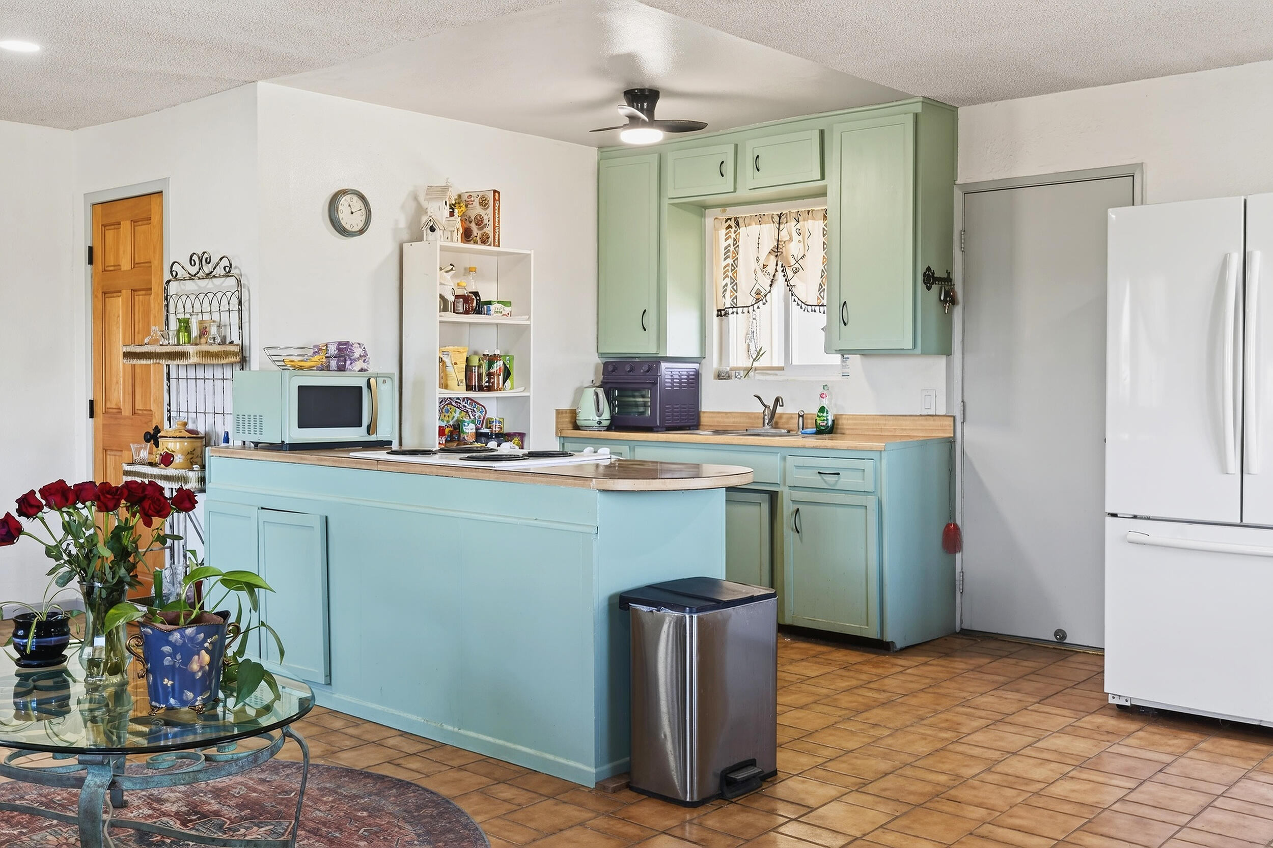 1588 Old Woman Springs Road Yucca Valley, CA 92284 - Photo 17 of 37 a kitchen with stainless steel appliances granite countertop a refrigerator and a sink