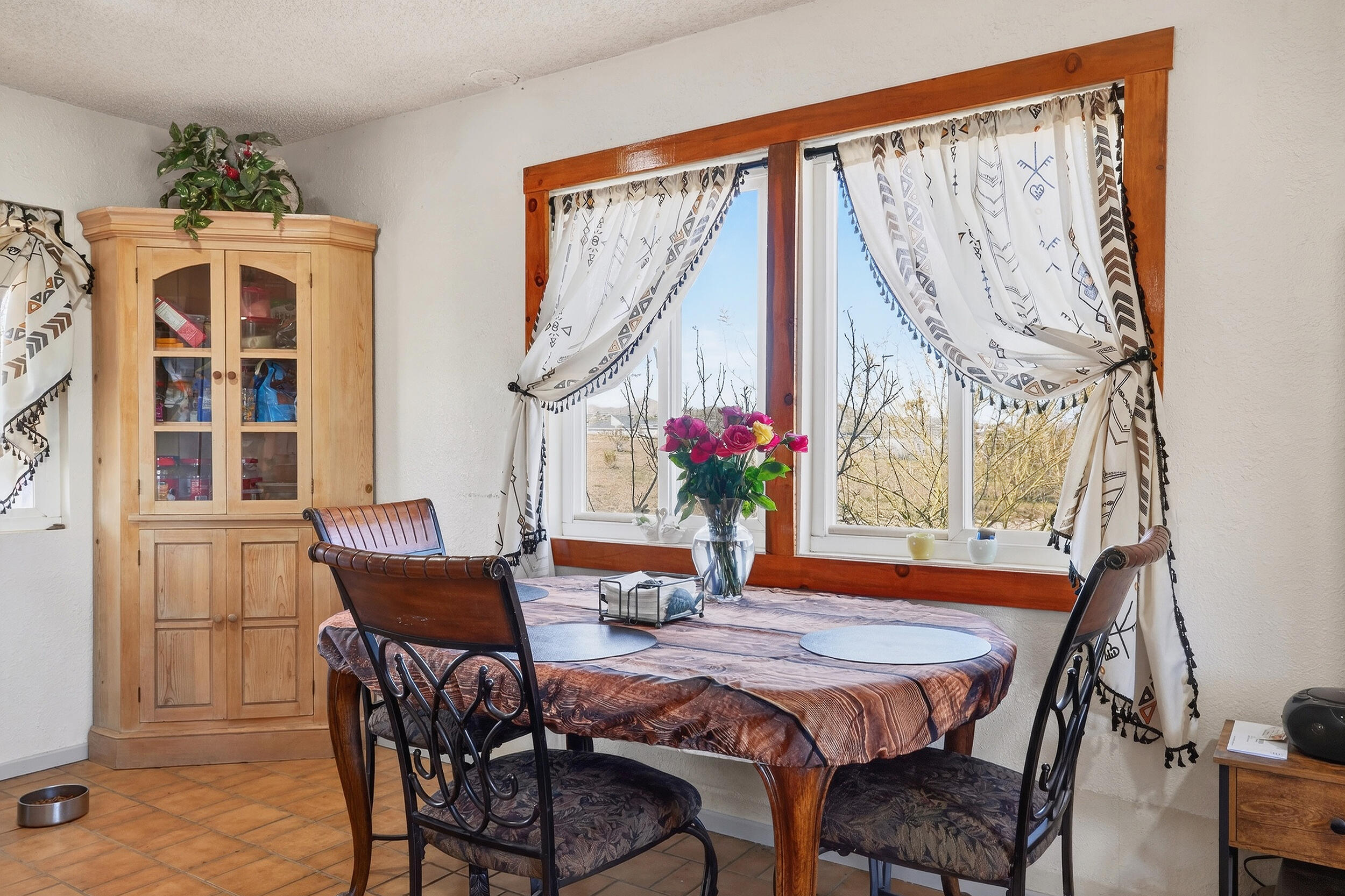 1588 Old Woman Springs Road Yucca Valley, CA 92284 - Photo 18 of 37 a dining room with furniture and window