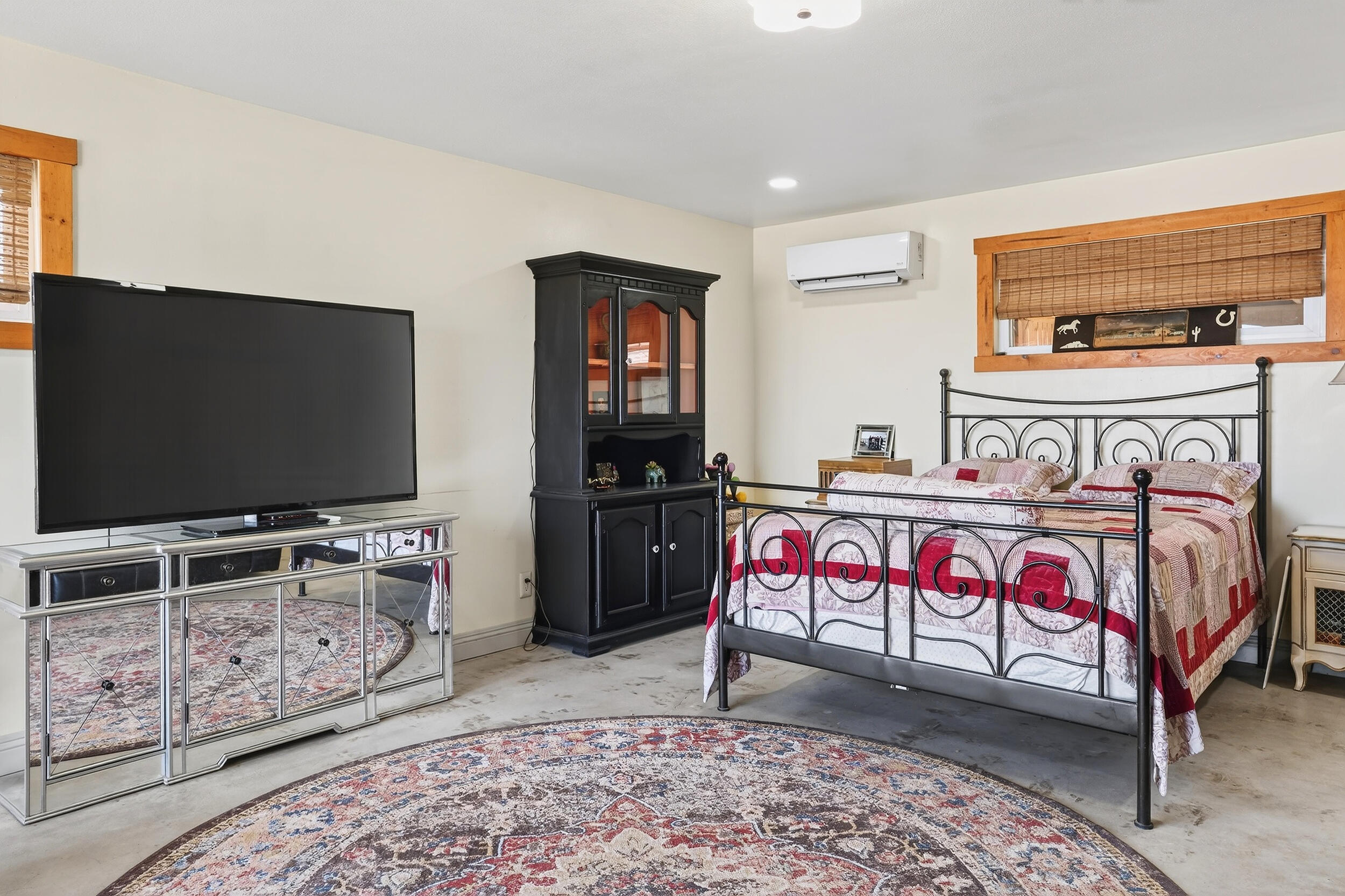 1588 Old Woman Springs Road Yucca Valley, CA 92284 - Photo 23 of 37 a bedroom with furniture and a flat screen tv