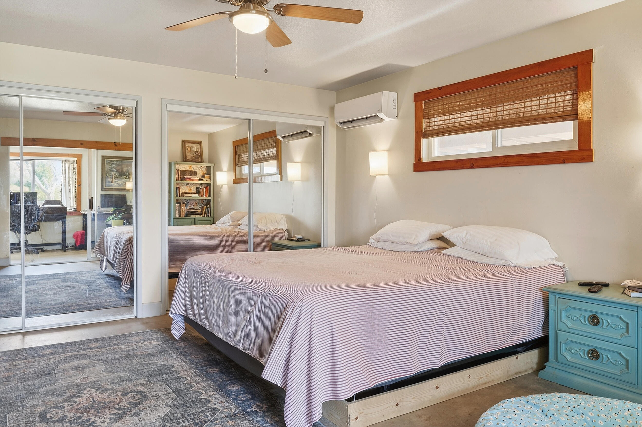 1588 Old Woman Springs Road Yucca Valley, CA 92284 - Photo 24 of 37 a bedroom with a bed and wooden floor