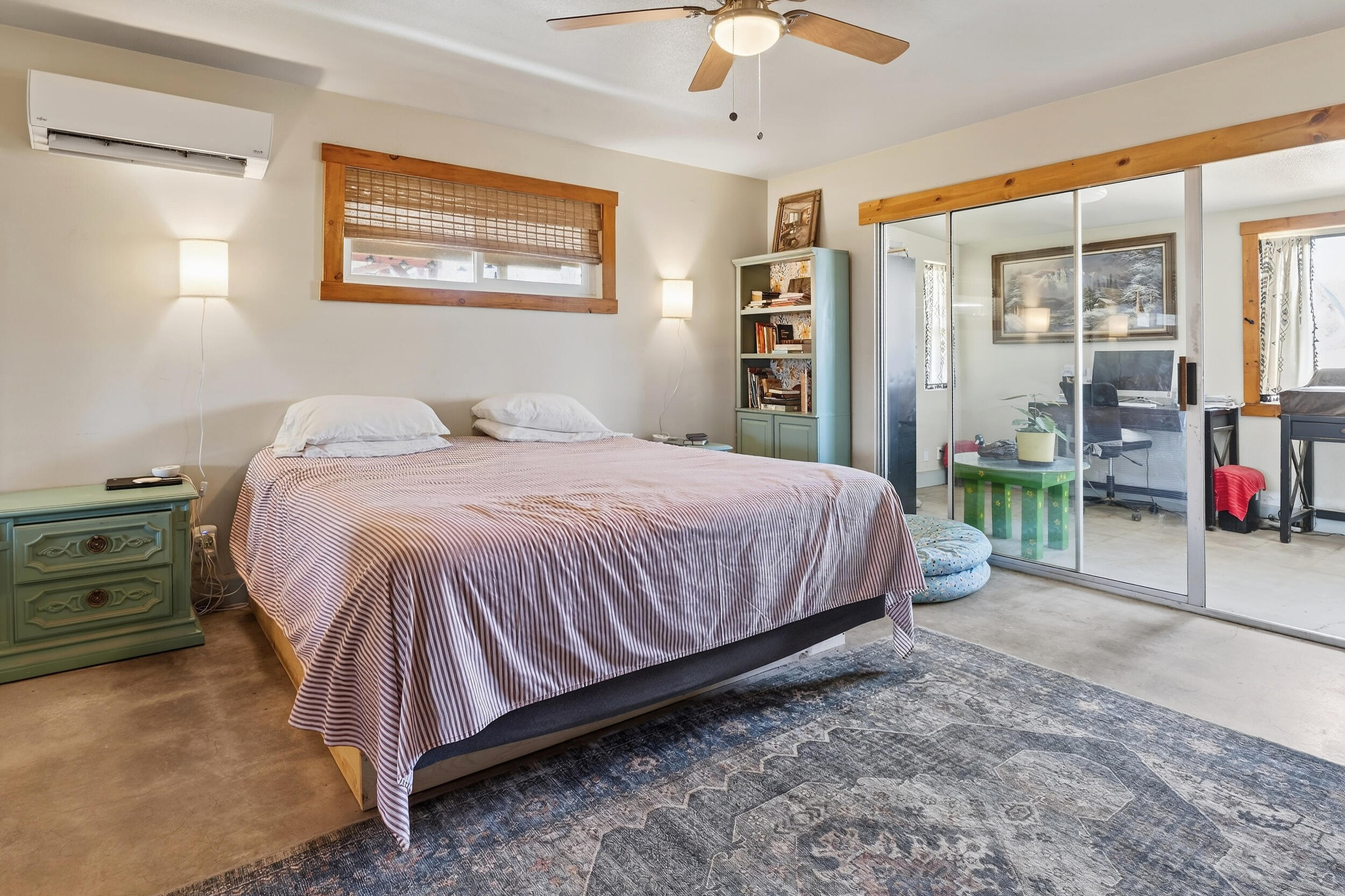1588 Old Woman Springs Road Yucca Valley, CA 92284 - Photo 25 of 37 a bedroom with a bed and a chandelier